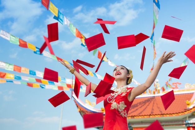 A beautiful asian girl wearing a red dress