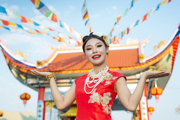 A beautiful asian girl wearing a red suit 