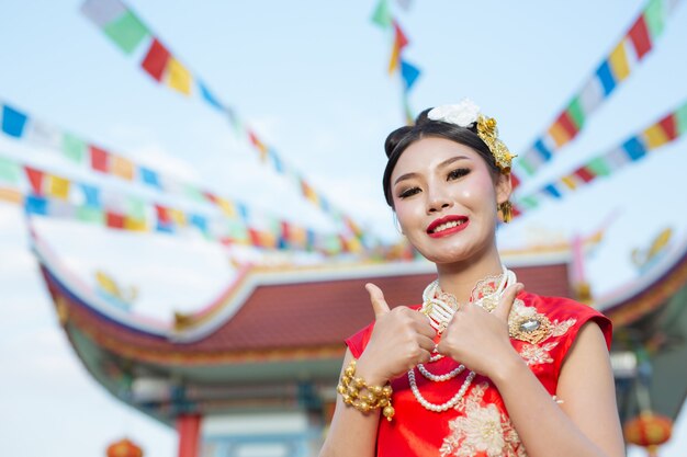 A beautiful asian girl wearing a red suit 