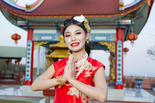 A beautiful Asian girl wearing a red worship