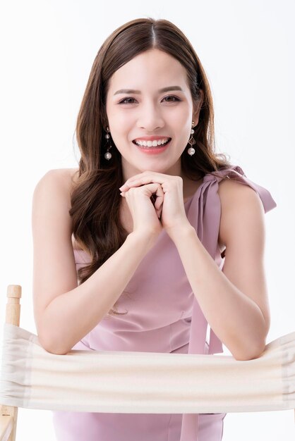 Beautiful asian presenter woman dress smile and look camera portrait white background