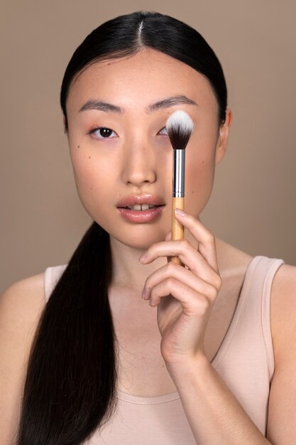 Beautiful asian woman applying makeup