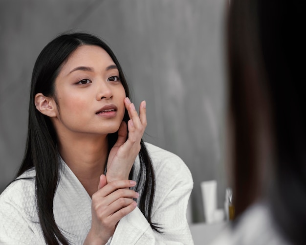 a confident woman facing the mirror