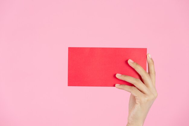 Beautiful Asian woman show something and take red envelopes in chinese new year