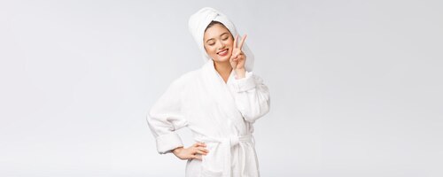 Beautiful asian woman showing peace sign or two finger with happy feeling isolated over white background