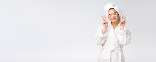 Beautiful asian woman showing peace sign or two finger with happy feeling Isolated over white background