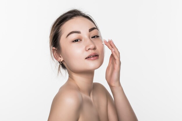 Beautiful asian woman washing her beauty face with cleansing foam on her hands for skin care isolated on white wall