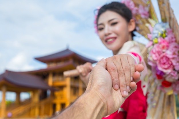 Free photo a beautiful asian woman wearing a japanese kimono, traditional dress concept.