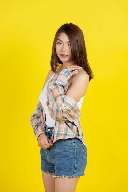 Stunning Portraits of a Beautiful Asian Woman against a Vibrant Yellow Wall
