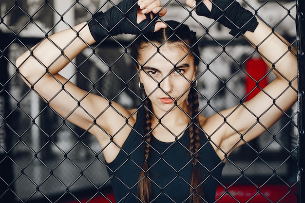 A beautiful and athletic sportswear girl training in the gym