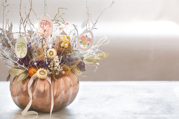 A beautiful autumn arrangement with flowers and pumpkin