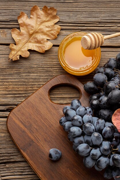 Beautiful autumn arrangement with honey and grapes