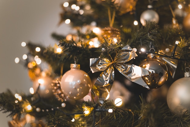 beautiful baubles and string lights hanging on a Christmas tree