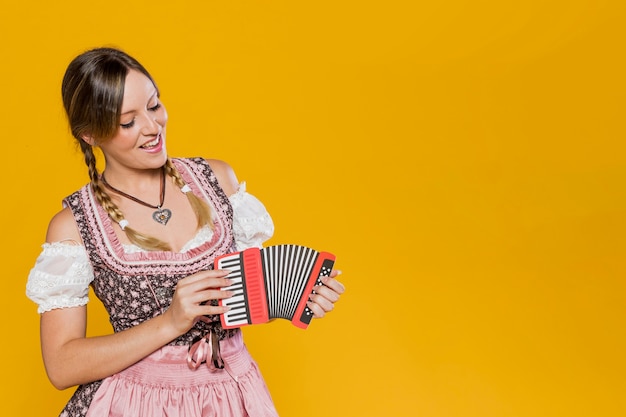 Beautiful bavarian girl with paper accordion