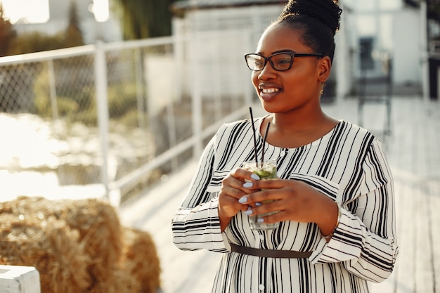 Beautiful black girl standing in a summer park