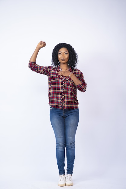 Beautiful black woman gesturing a pledge with hand on her heart