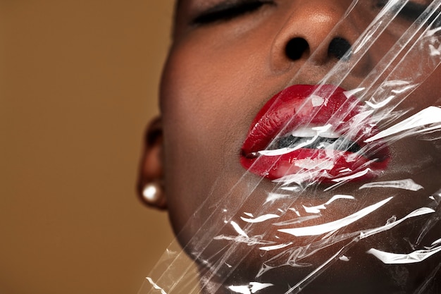 Free photo beautiful black woman behind a plastic wrap wallpaper