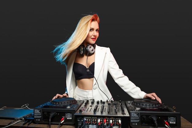 Beautiful blonde DJ girl on decks - the party,