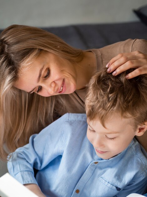 Beautiful blonde mother looking after young boy