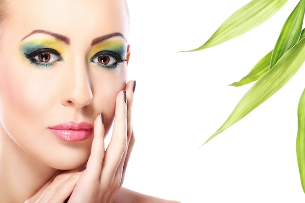 Beautiful blonde with bamboo leaves