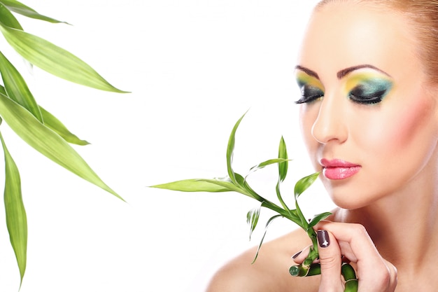 Beautiful blonde with bamboo leaves