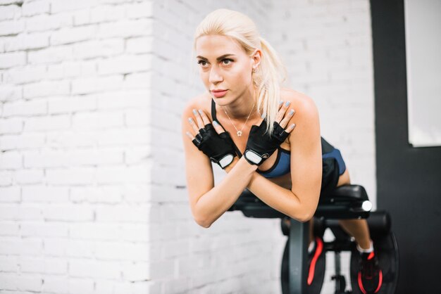 Beautiful blonde woman doing back extensions