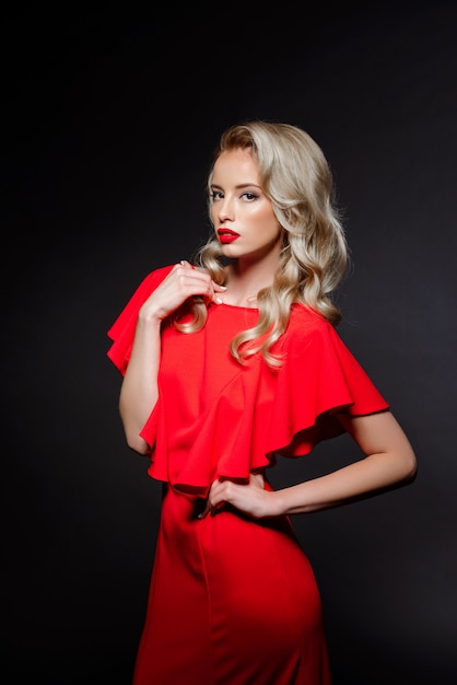Free photo beautiful blonde woman in red evening dress