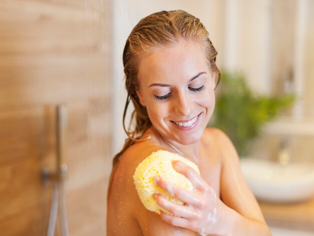 Beautiful blonde woman taking shower