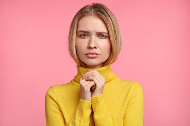 Beautiful blonde woman with yellow turtleneck