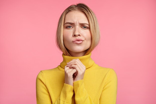 Beautiful blonde woman with yellow turtleneck