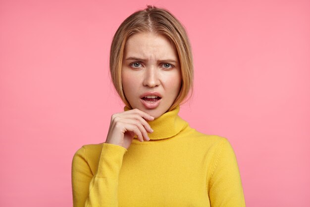 Beautiful blonde woman with yellow turtleneck