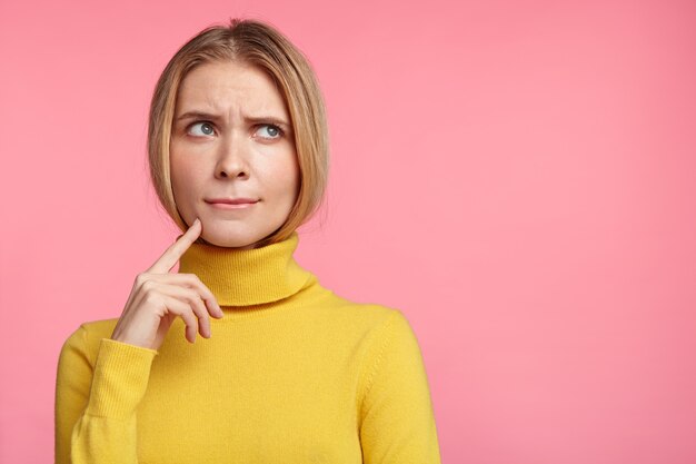 Beautiful blonde woman with yellow turtleneck