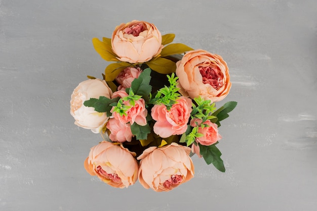 Beautiful bouquet of pink roses on grey surface