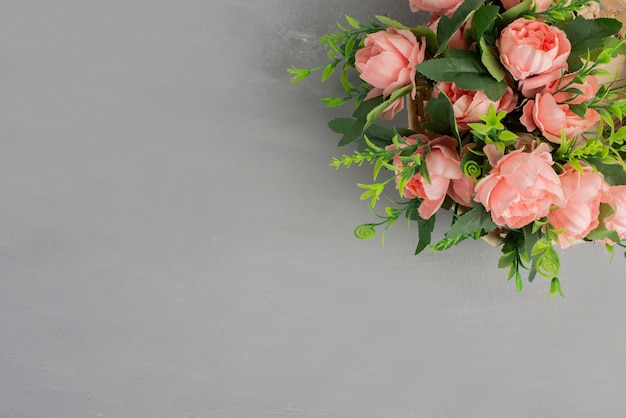 Beautiful bouquet of pink roses on grey table.