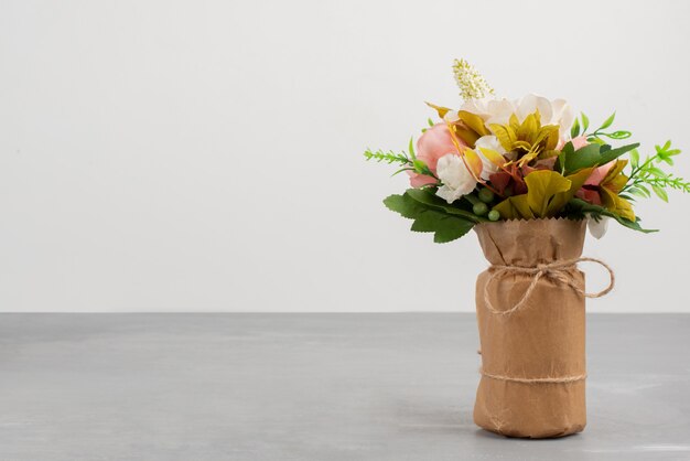 Beautiful bouquet of pink roses on grey table.