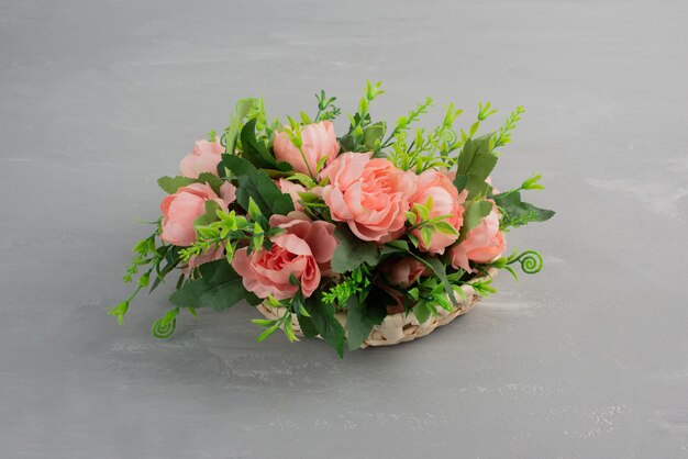 Beautiful bouquet of pink roses on grey table.