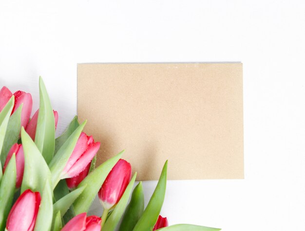 Beautiful bouquet of tulips with blank greeting card