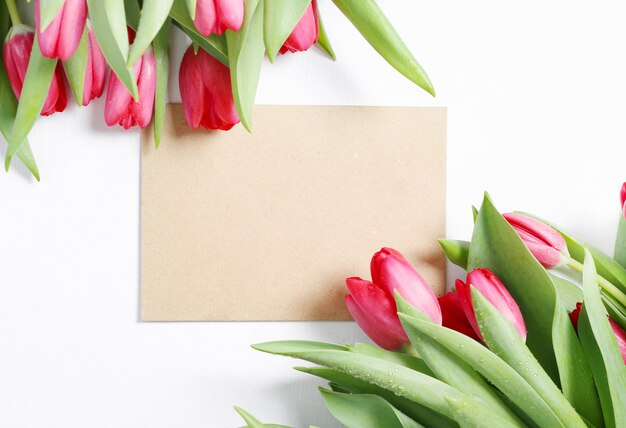 Beautiful bouquet of tulips with blank greeting card