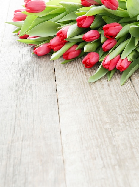 Beautiful bouquet of tulips on wooden table