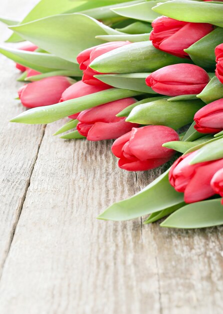 Beautiful bouquet of tulips on wooden table