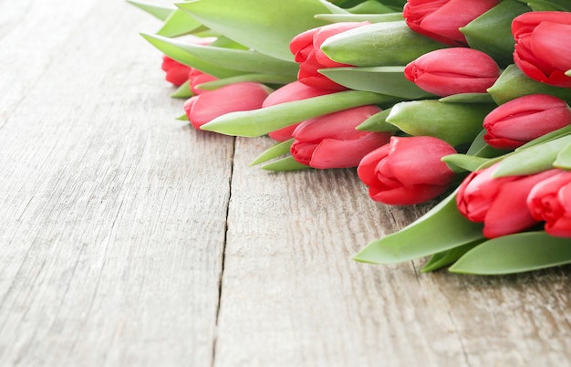 Beautiful bouquet of tulips on wooden table