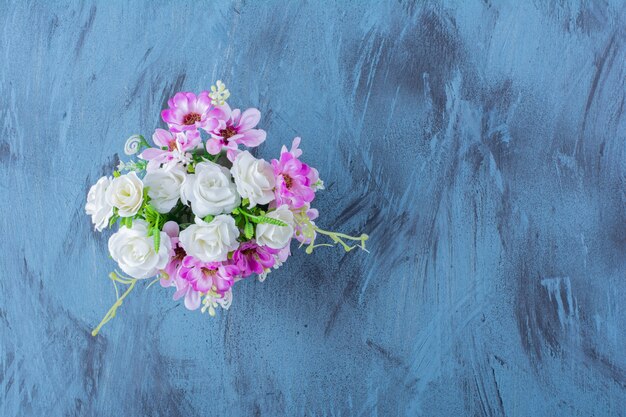 Beautiful bouquet of various types of flowers on blue.