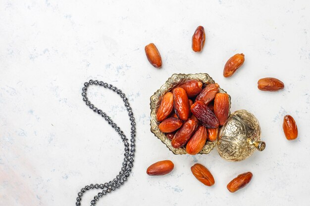 Beautiful bowl full of date fruits symbolizing Ramadan, top view