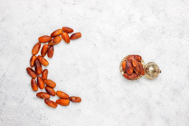 Beautiful bowl full of date fruits symbolizing Ramadan, top view