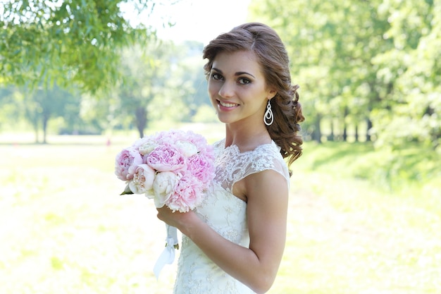 Beautiful bride in curly updo in tha nature