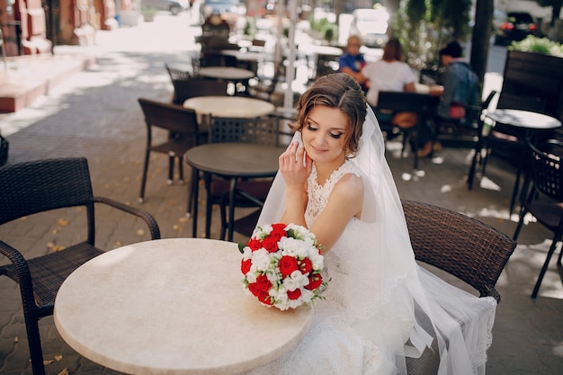 Beautiful bride looking at her bouquet