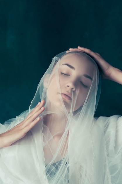 Beautiful bride looking over her veil