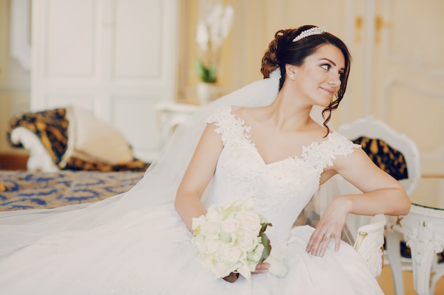 beautiful bride in a magnificent white dress and a crown on his head 