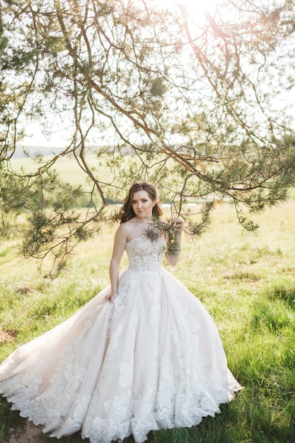 Beautiful bride near the tree