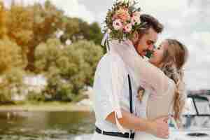 Free photo beautiful bride with her husband in a park